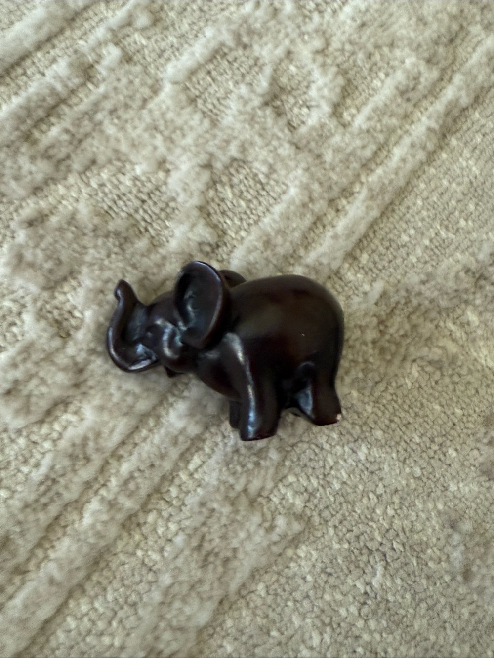 Small dark brown carved elephant animal figurine